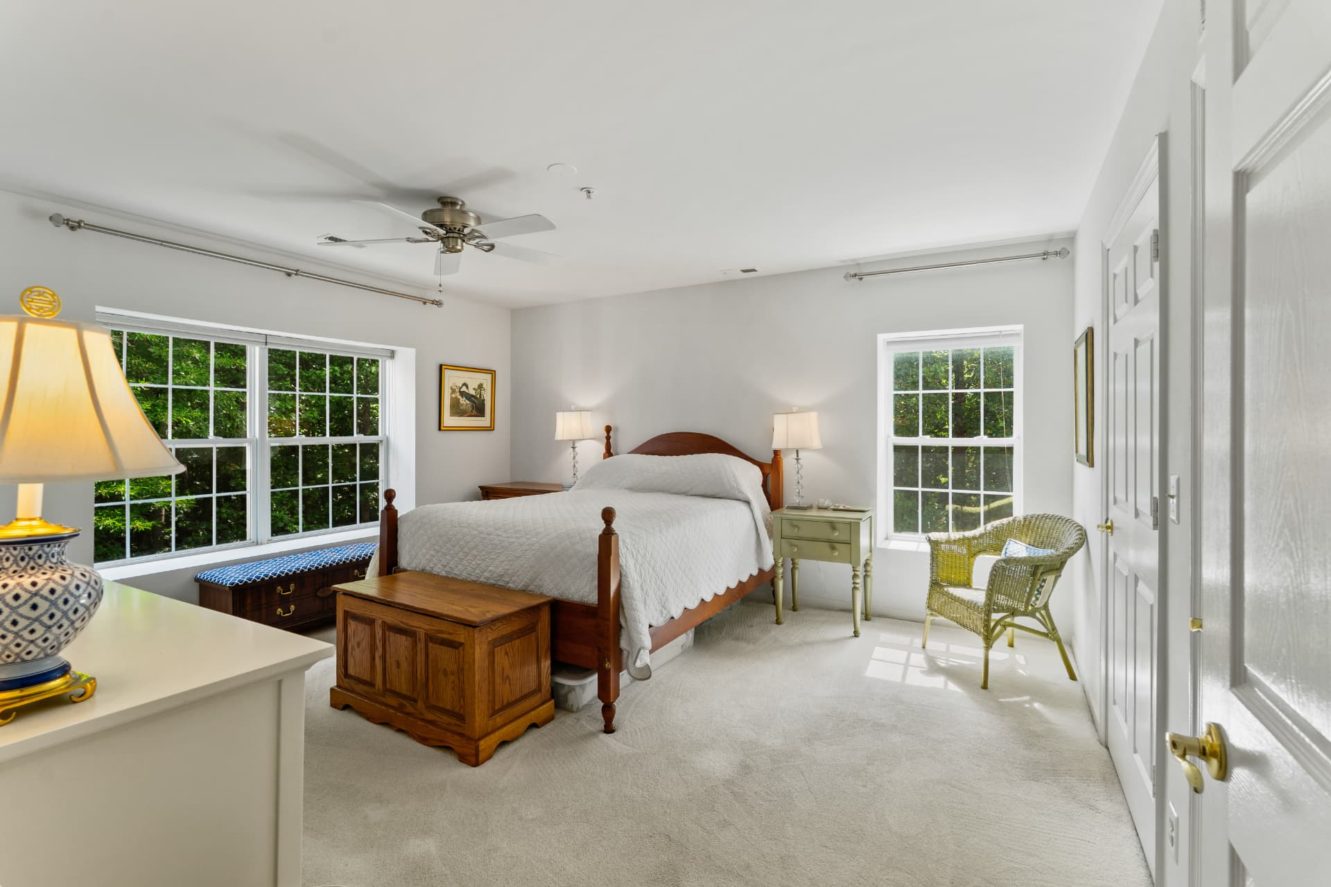 508 Limerick Circle Unit 303 — bright primary bedroom with ceiling fan, carpet and two large windows