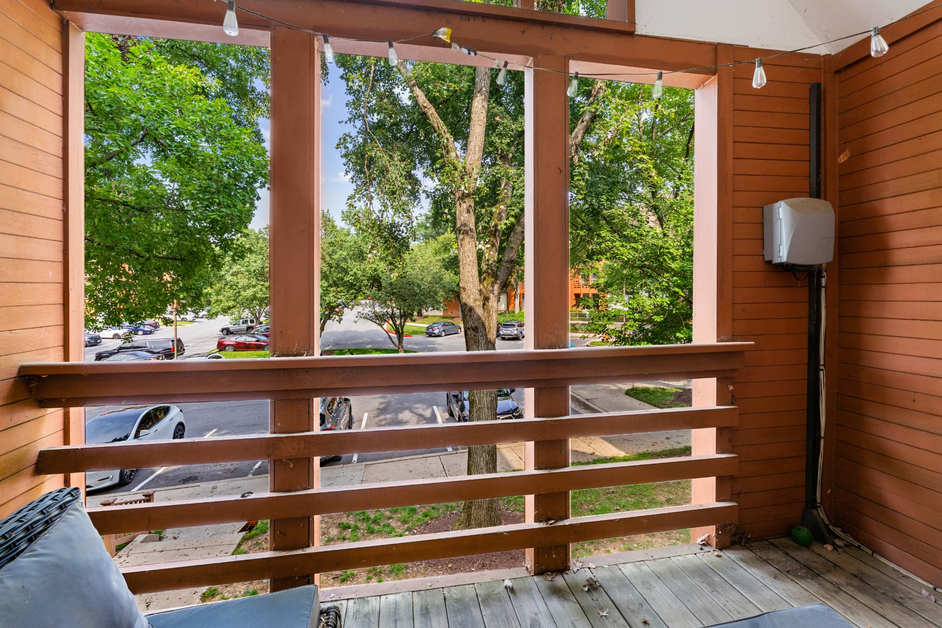 4924 Columbia Road Unit 5 — covered balcony overlooking mature trees and courtyard