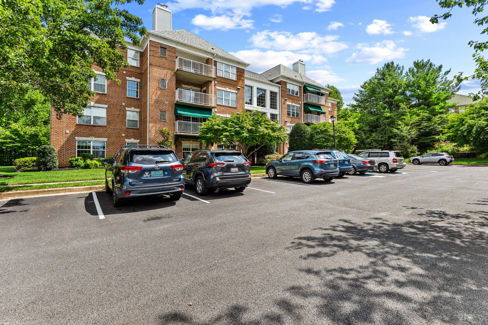 508 Limerick Circle Unit 303 — side view of the brick condo building with balconies