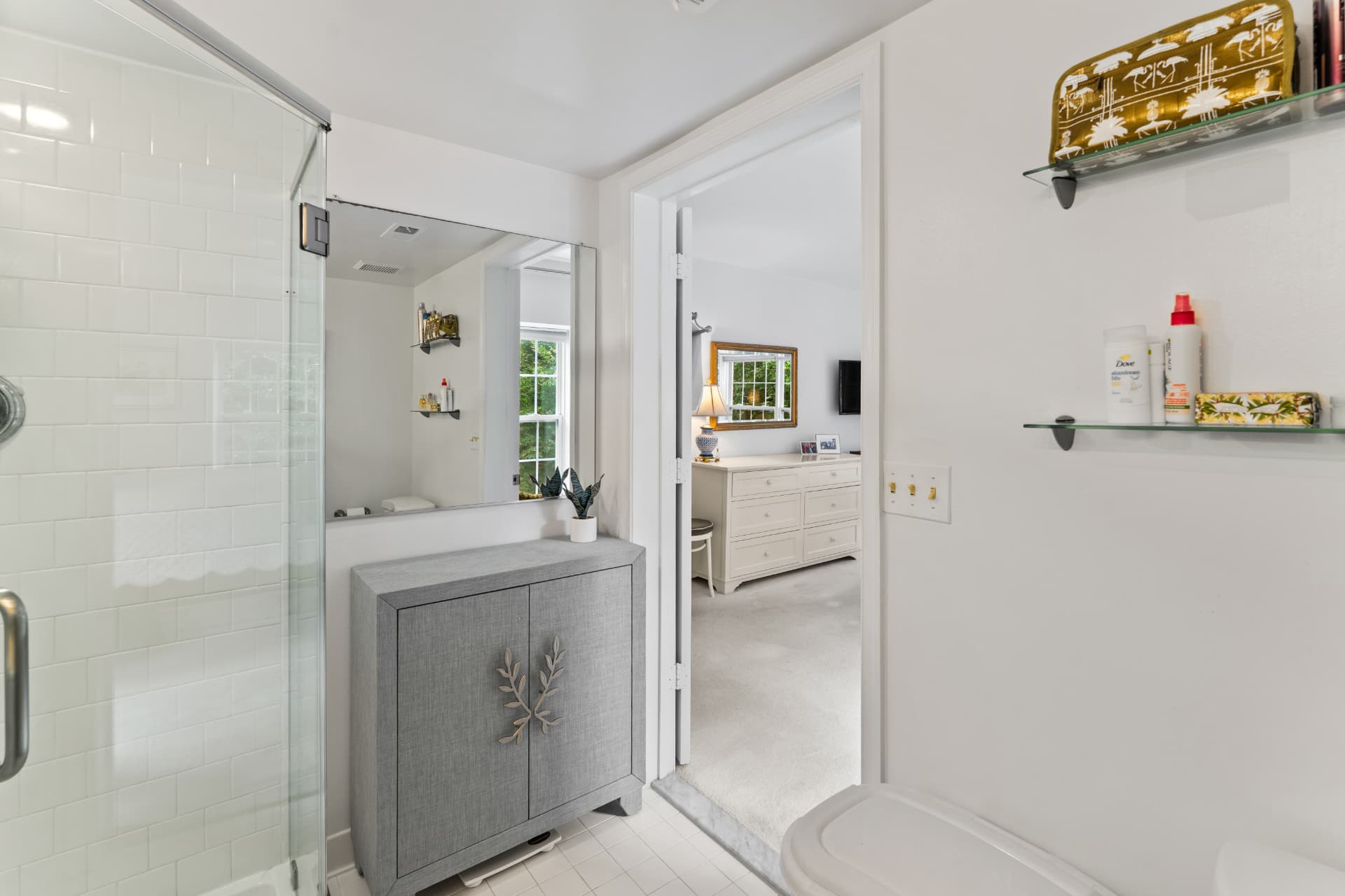 508 Limerick Circle Unit 303 — en-suite bathroom with glass shower, mirrored vanity and view into the bedroom