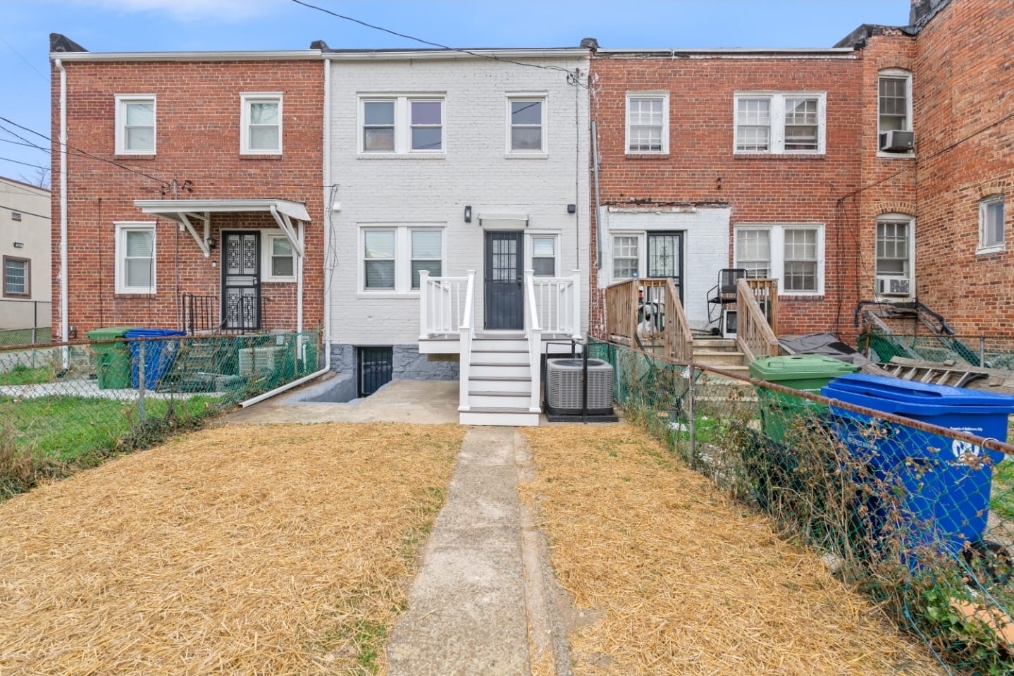 Renovated Baltimore rowhome exterior with white brick facade